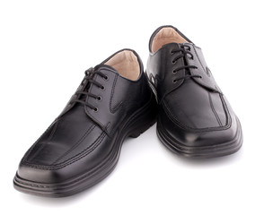 Black glossy man’s shoes with shoelaces