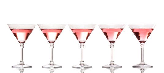 Red cocktail in martini glasses isolated on white