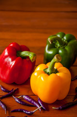Yellow, Red and Green Bell Peppers with Purple chili