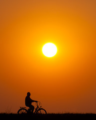 Fototapeta na wymiar Silhouette of senior man riding bicycle