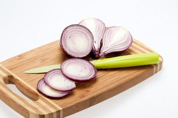 Red onions on a wooden board