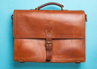 Brown Vintage leather briefcase on bright blue background