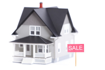 Household architectural model with sale sign, isolated