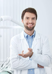 Smiley dentist welcomes the patient - 43757725
