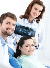Fototapeta premium Dentist, assistant and client are satisfied of their work