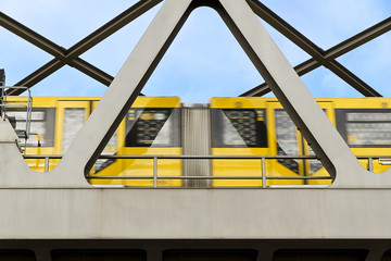 yellow moving tram on a bridge in berlin