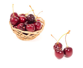 ripe cherries in basket isolated on white background
