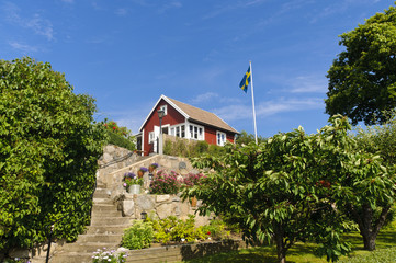 Red cottage and Swedish flag