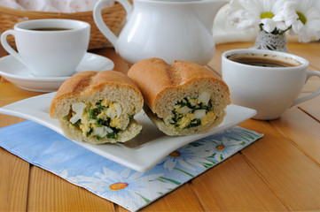 Baguette stuffed with spinach, onion and egg