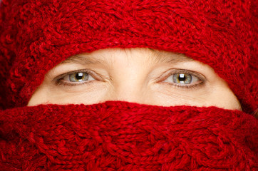 Middle-aged woman wrapped up in red scarf