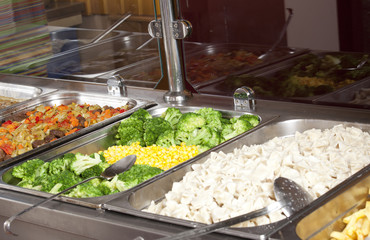 chef standing behind full lunch service station 