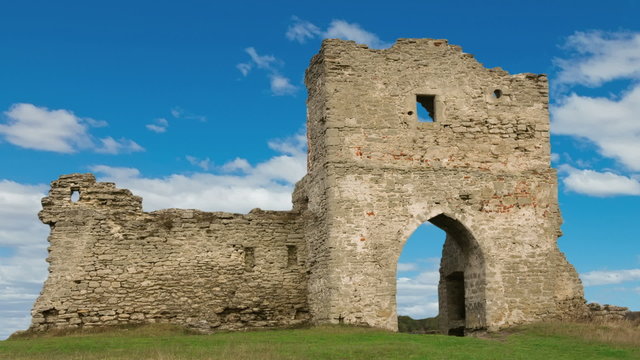 Ruined gates of cossack castle with blue sky and clouds