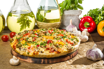 Baked pizza and bottles of olive oil