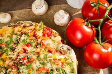 Close-up of pizzas and baked tomatoes