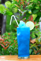 Blue Hawaiian cocktail blend with lemon and green background