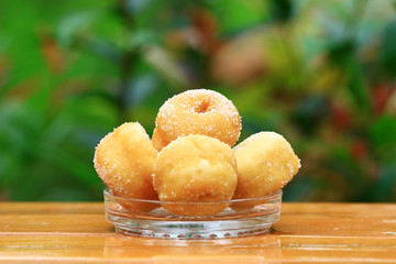 Donut sugar in dish on wood table