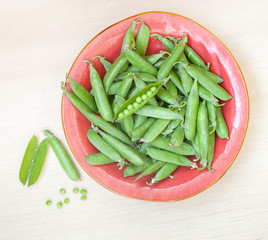 Peas pods on a plate top view