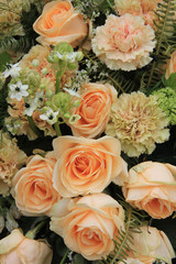 Carnations and roses in pale orange