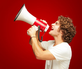 Portrait Of Young Man Shouting With A Megaphone 