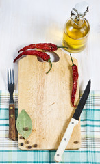 Chopping board, pepper, fork and knife