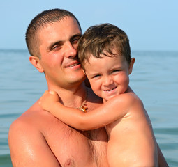 Man with a boy at the seaside