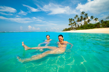 Two women having fun in the ocean