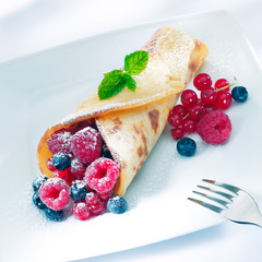 Berry pancake sprinkled with sugar