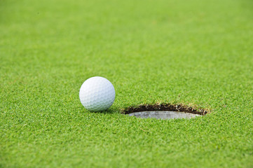 Golf Ball on Edge of Hole