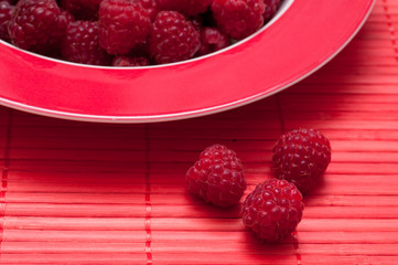 Reife Himbeeren auf roten Untergrund