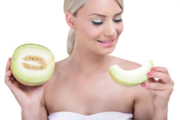 Beautiful woman holding a slice of melon