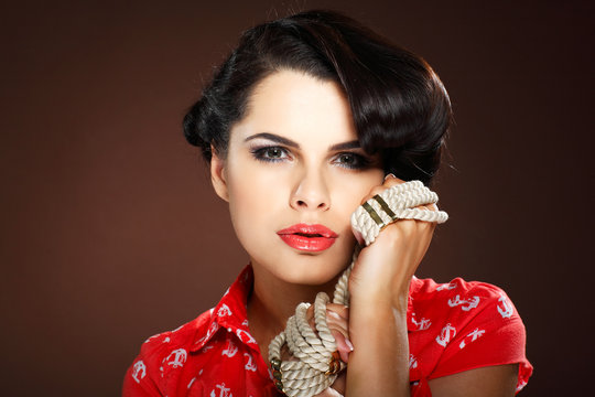 Fototapeta A photo of beautiful brunette is in style of pinup, glamur