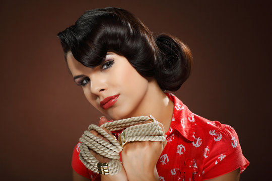 Fototapeta A photo of beautiful brunette is in style of pinup, glamur