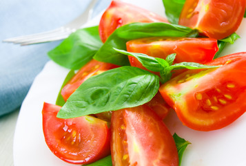 Fresh tomatoes with basil leaves