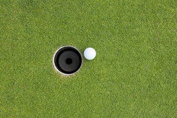 Golf Ball on Edge of Hole - 43804978