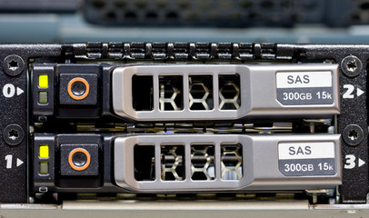 Row of hard drives mounted in a rack in a data center