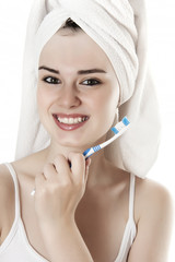 young woman brushing her teeth