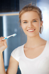 smiling teenage girl with toothbrush