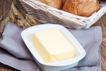 Fresh butter and crispy rolls in the background © Kamila Cyganek
