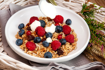 muesli with frutis and a spoon of yogurt