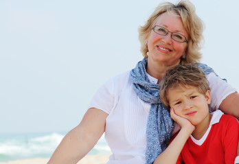 Fototapeta na wymiar happy grandma and grandson on vacation at sea