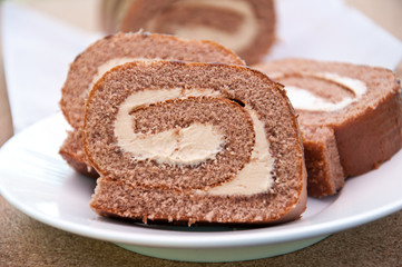 Swiss Sponge Roll With Cream on White Plate 