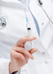 Doctor hands a syringe, isolated on white