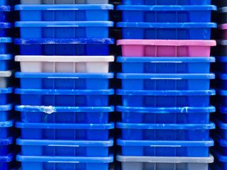 Stack of empty colorful plastic fishery containers