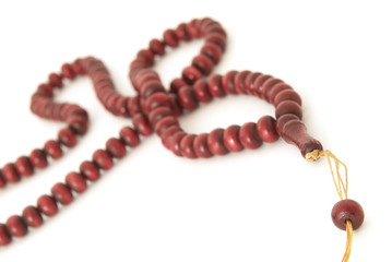 Rosary beads on white background