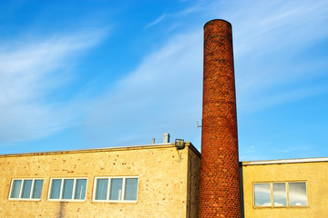 Fototapeta premium Brick smokestack in old industrial building