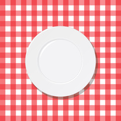 White plate on a checkered red tablecloth