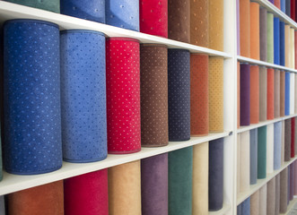 colorful carpets samples on the shelves
