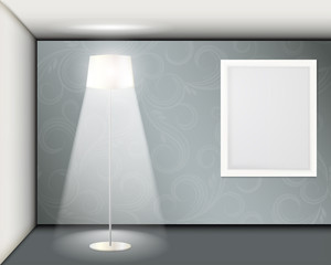 White frame on the wall. A room with a floor lamp.