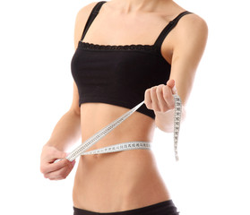 Athletic woman with measure tape isolated on white background