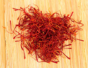 Fototapeta premium stigmas of saffron on wooden background close-up